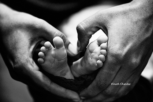 hands around a baby's feet