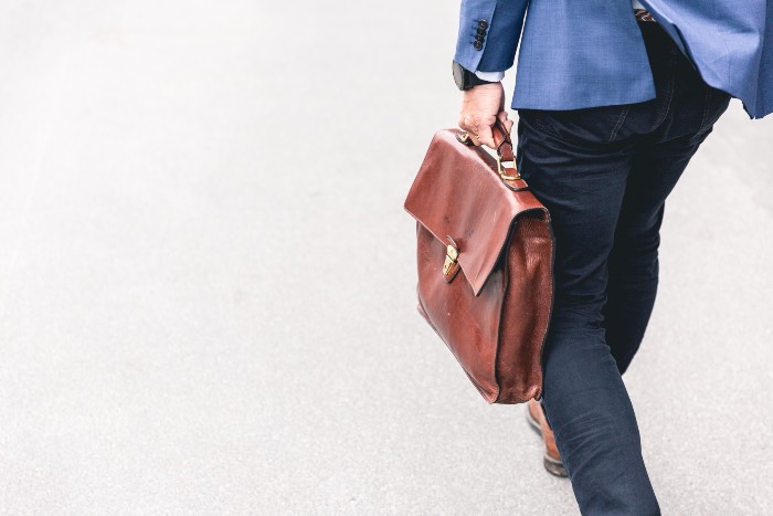 - a photo of a person carrying a briefcase