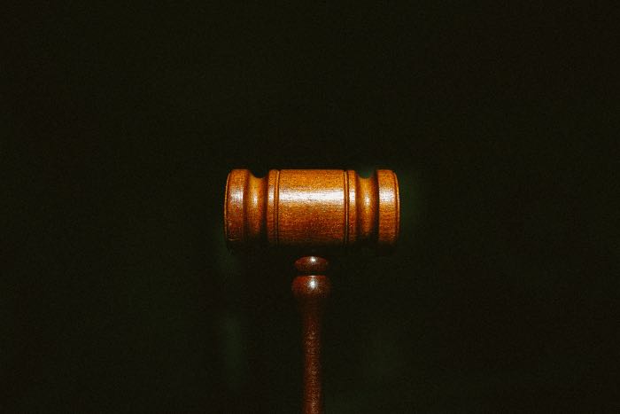 "Persistence as an act of resistance" - a photo of a gavel in front of a black background