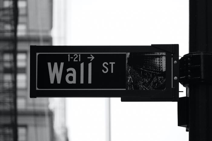 "Treated the same, only different" - a photo of a street sign that says "Wall St".