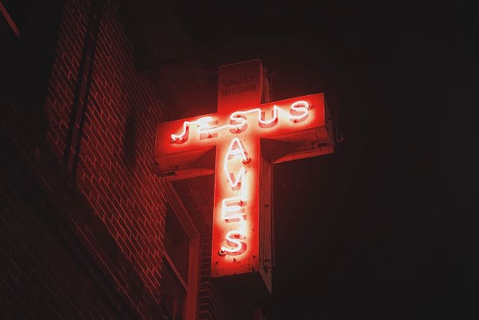 "It Means Saving" - a photo of a neon sign that reads "Jesus Saves".