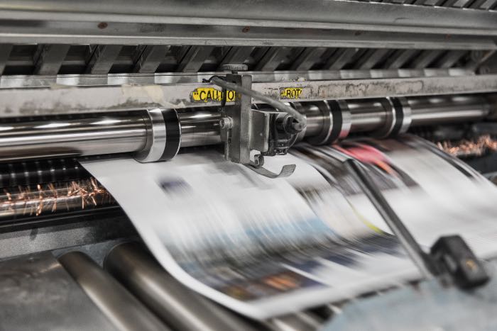 "Being Good News" - a photo of a newspaper being printed.