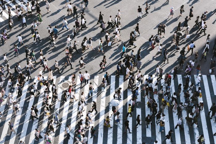 "The Word became flesh" - a photo from above of many people crossing a street.
