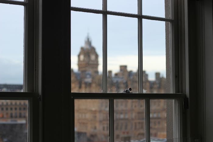 "blessing" - a photo of London from inside. The camera's focus is on the window.
