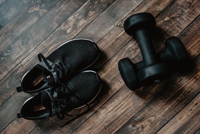 "No Resolutions" - a photo of workout shoes and a pair of hand weights.