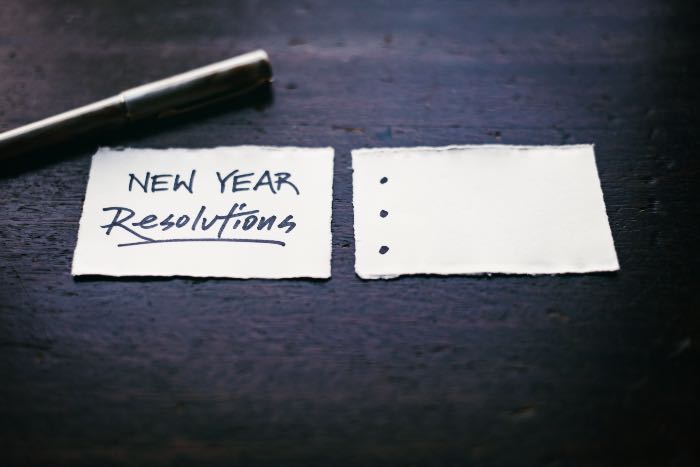 "The perfect time to start resolutions" - a photo of two cards. One reads "New Year Resolutions" and the other has three bullet points.