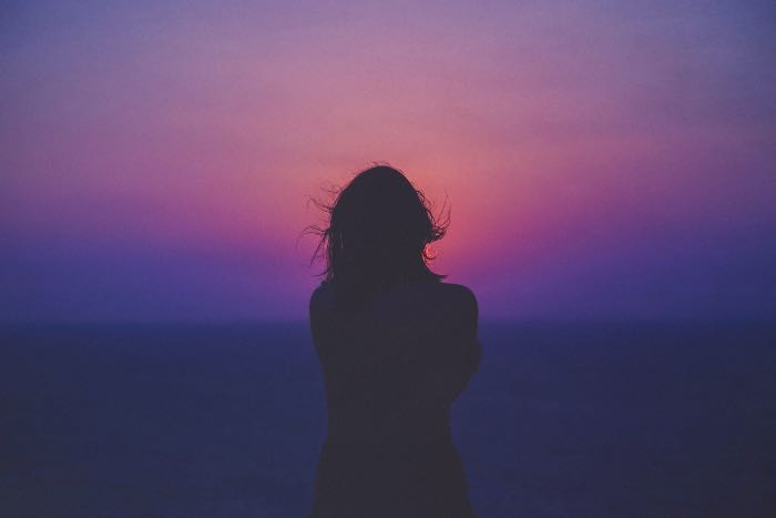 a photo of a person, backlit by the dusk after sunset