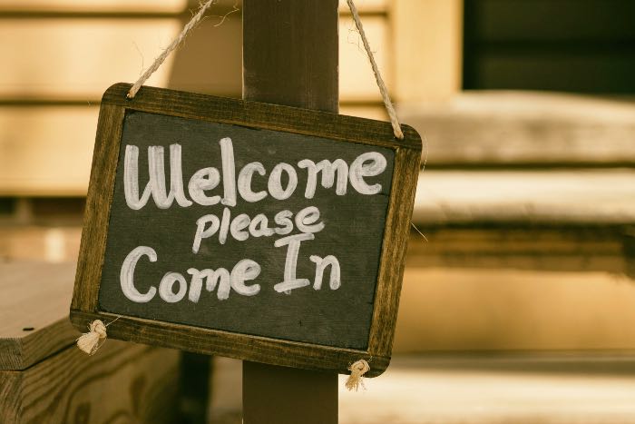 a photo of a sign that reads "Welcome please come in"