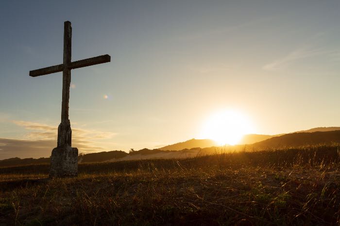 a photo of a large outdoor cross at sunset