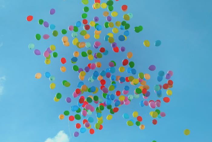 photo of many colorful balloons in the air