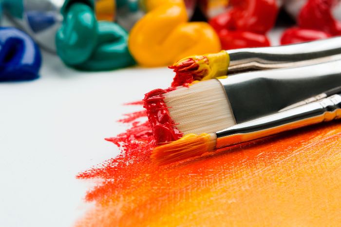 a photo of paint and brushes