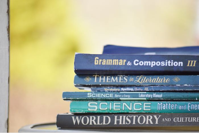 a photo of text books, including Grammar & Composition, Science, and World History.