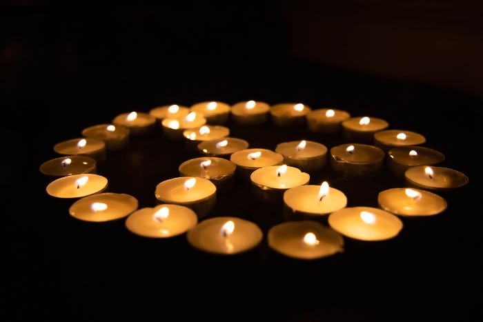 a photo of votive candles arranged in a peace sign.