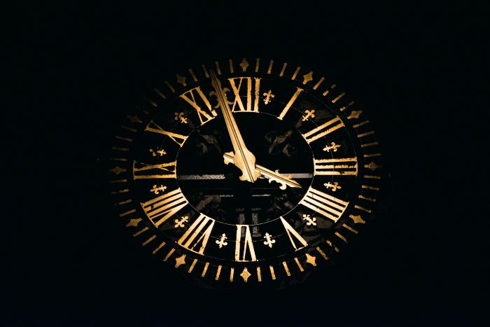 a photo of a clock face in the dark.