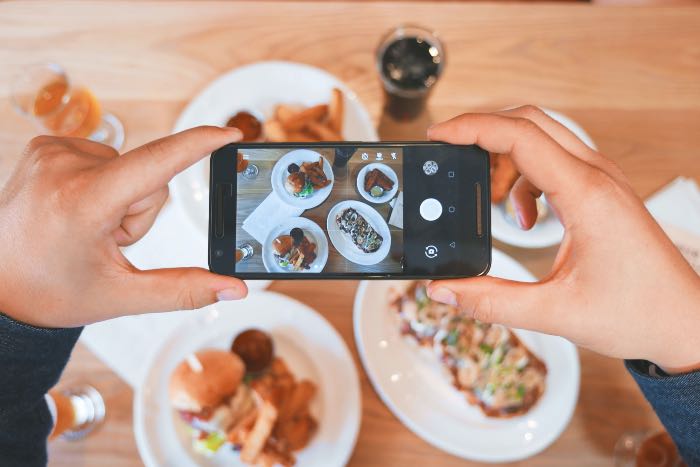 a photo of a person taking a picture of their food