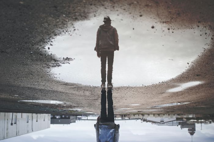 a photo of a person's reflection in a puddle