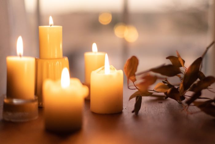 a photo of candles on a table, establishing a warm scene