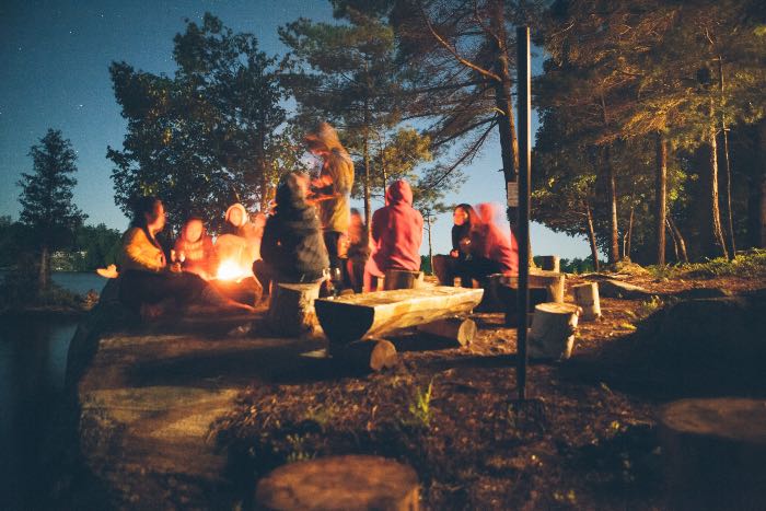 a photo of people around a campfire