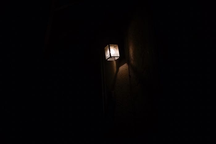 a photo of exterior light while all around it is darkness