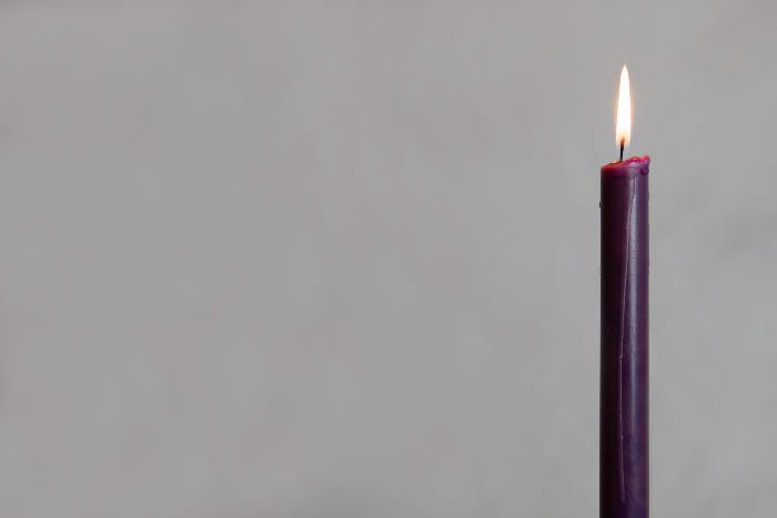 a photo of one purple candle