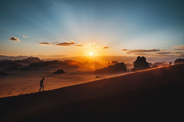 a photo of a person walking in the desert