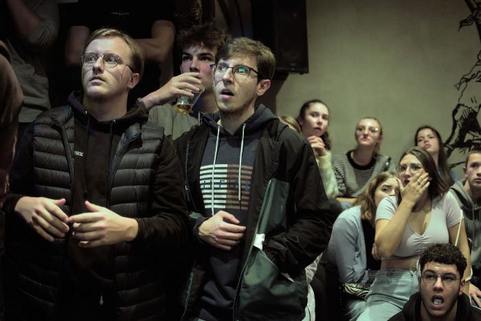 a photo of surprised fans watching a game