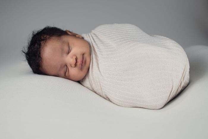 a photo of a baby swaddled and sleeping