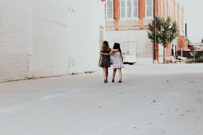 a photo of two small girls, walking together