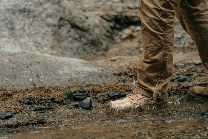 a photo of a person walking through mud