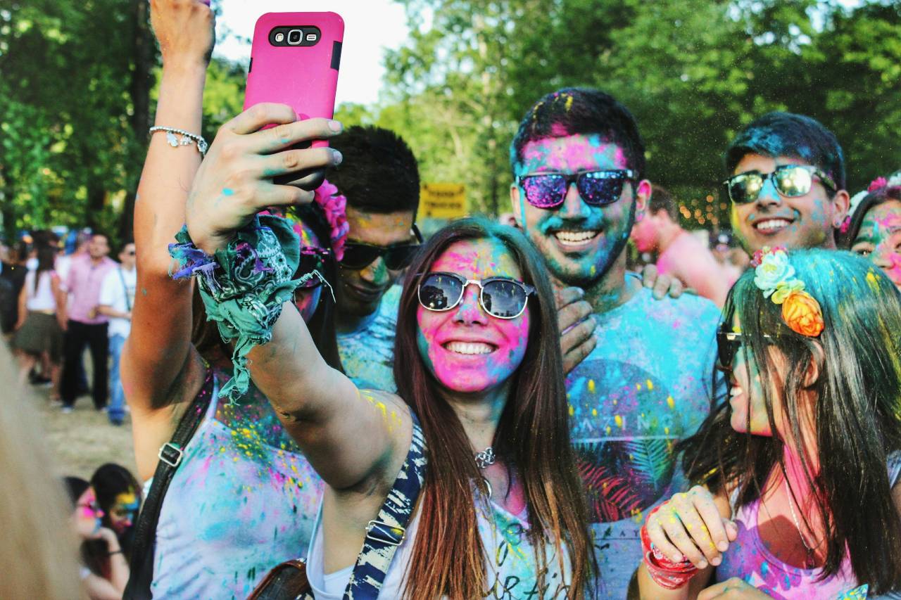 a photo of a people taking a selfie covered in colored paint