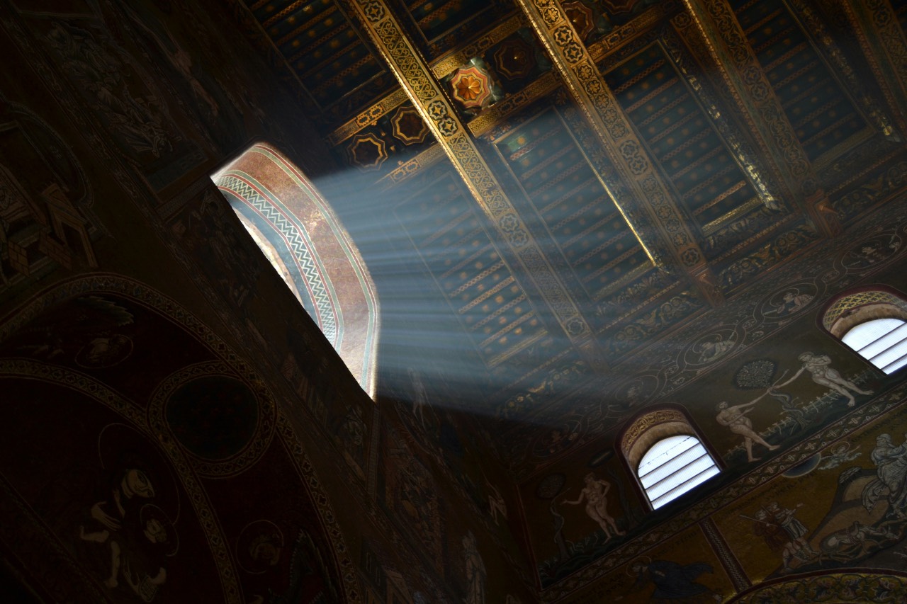 a photo of a high window in an old building, light coming through