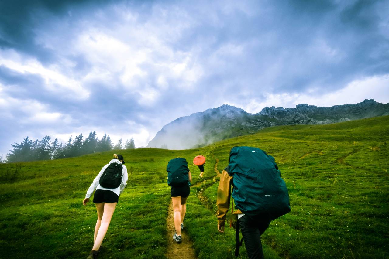 a photo of a group of people following up a mountain