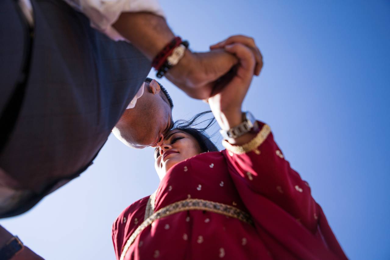 a photo of two people, holding hands, heads touching