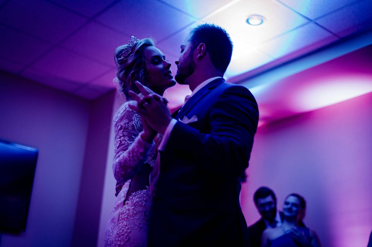 a couple dancing in the purple light