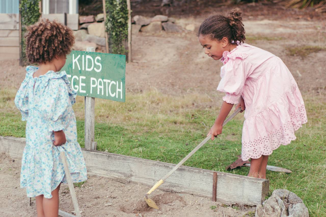 a photo of two children working in a garden