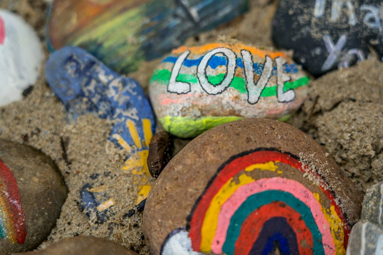 a photo of painted stones, one has the word "LOVE"