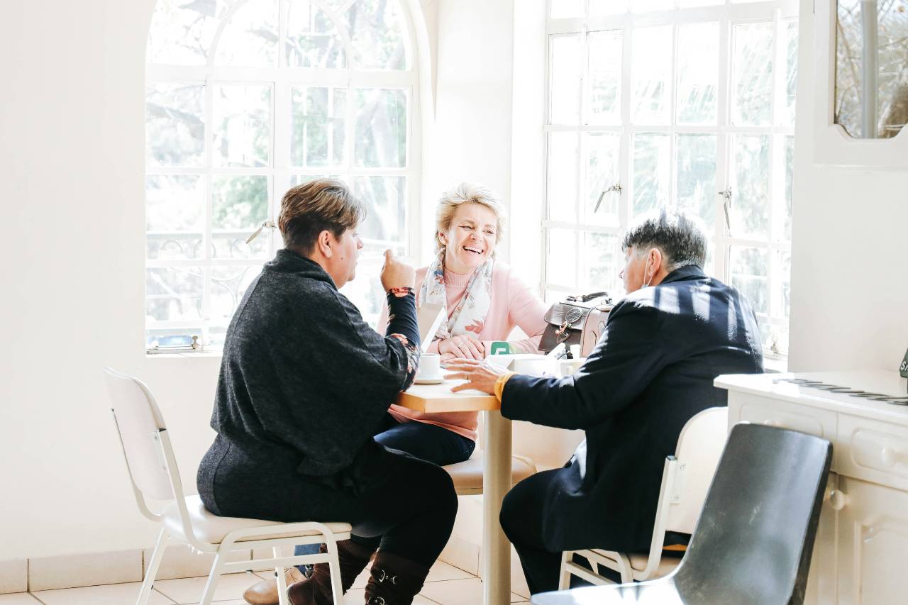 a photo of people at a table, talking