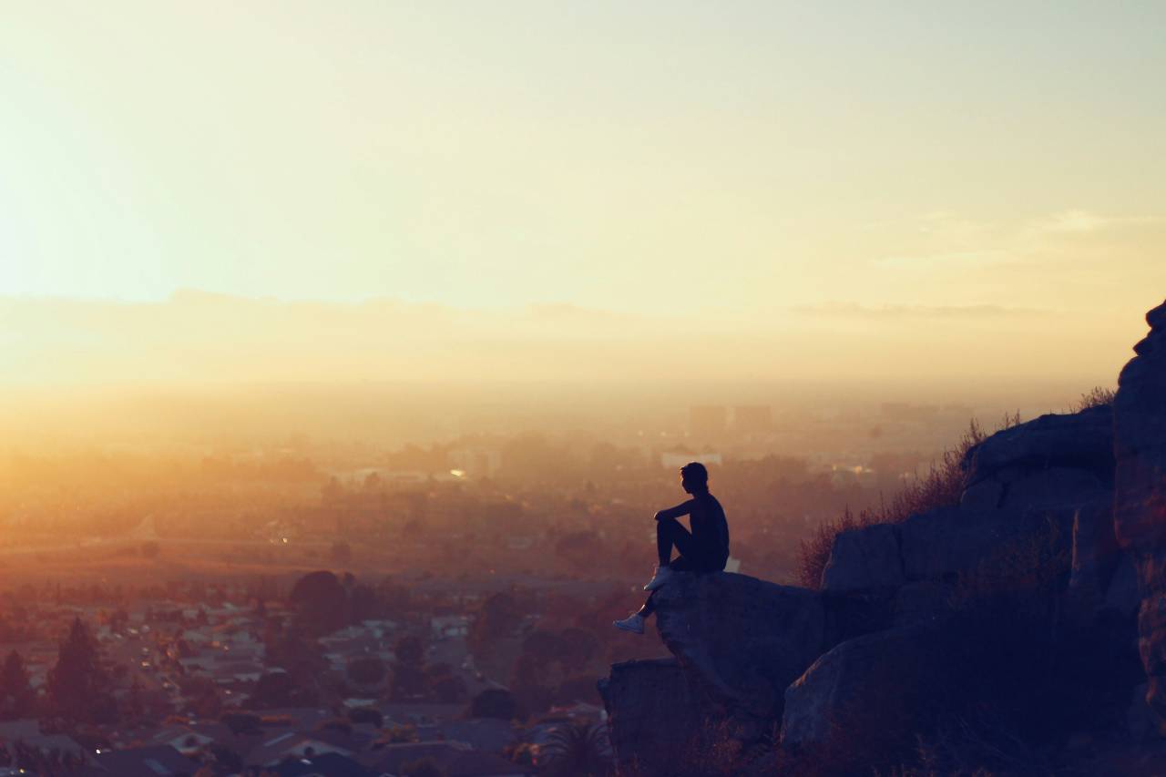 a photo of a person sitting on a mountain