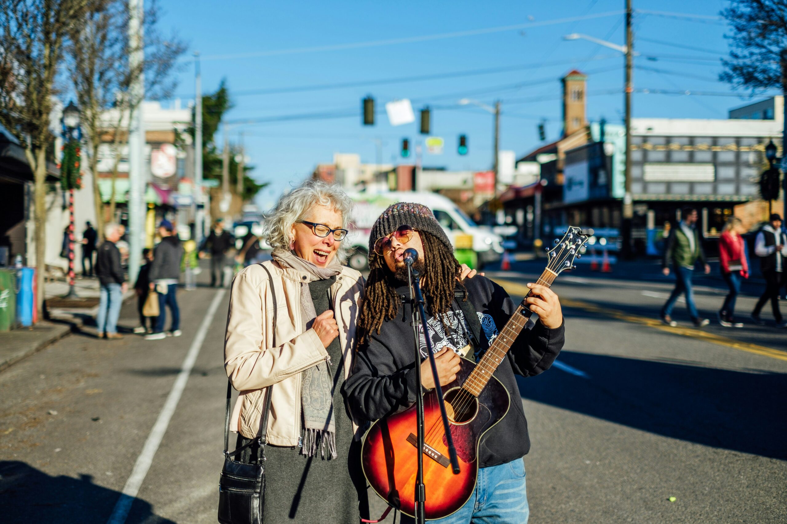 a photo of two people singing in a street