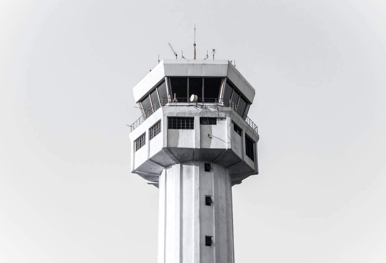 grayscale picture of a concrete prison guard tower