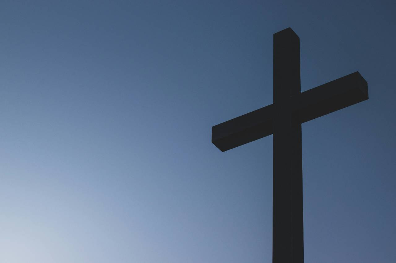a cross with sky behind it