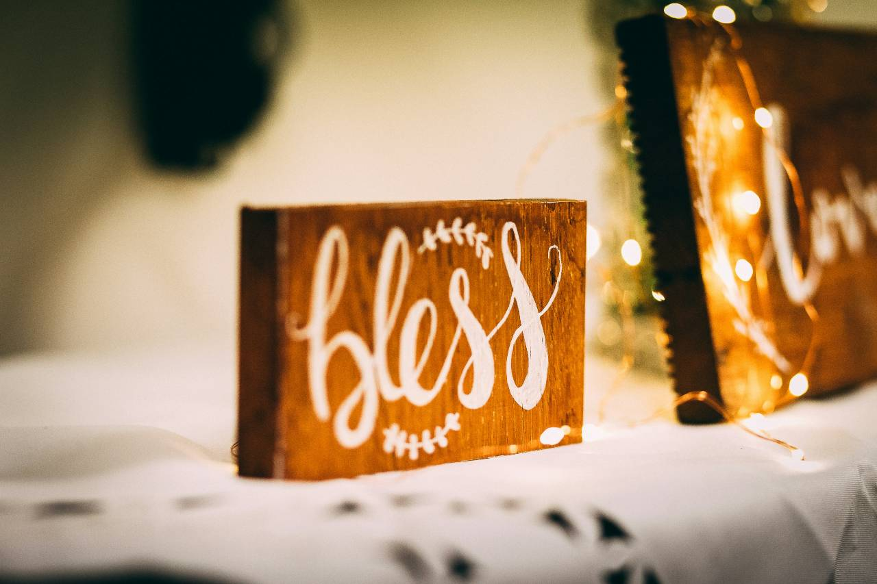 a wooden decoration that says "bless"