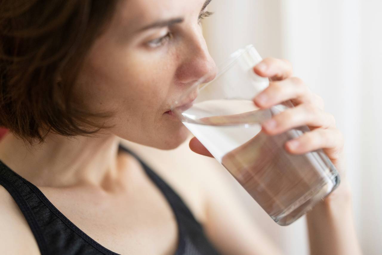 a person drinking a glass of water
