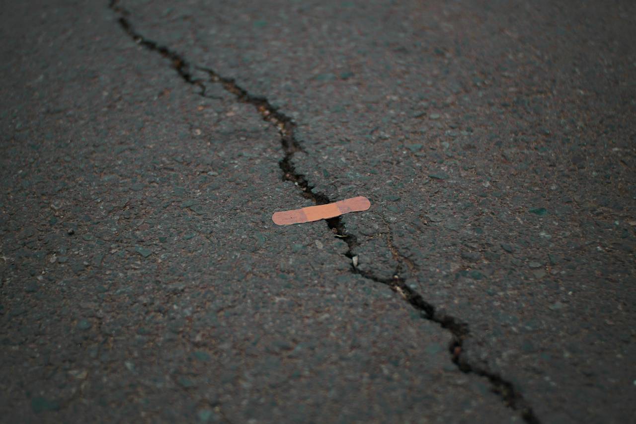 a bandage placed across a crack in pavement