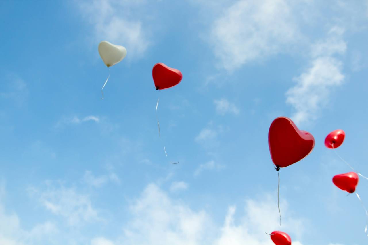 heart balloons flying away