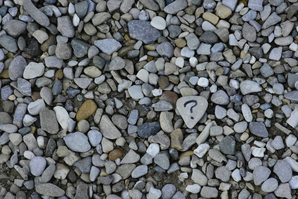 questions - stones with a question mark on one